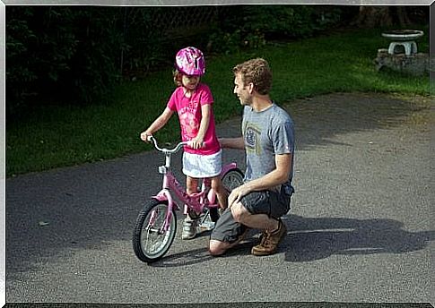 Father cycling with his daughter