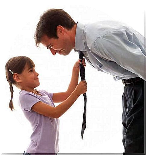 Father teaches his daughter to tie a tie