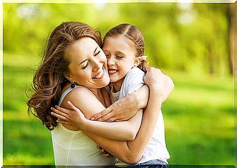 Mom and daughter in the park - a hug