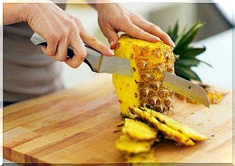 Slicing pineapple Fruit detox with pineapple and papaya