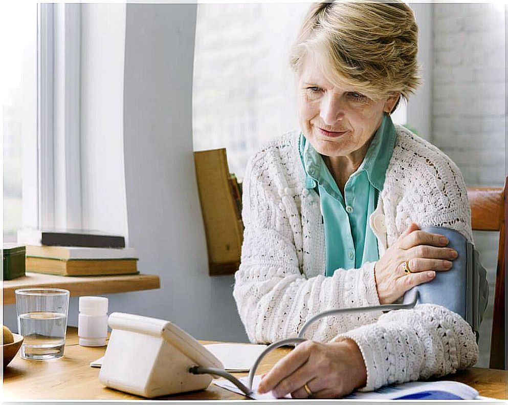 elderly woman measuring blood pressure