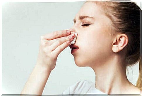 A woman with a handkerchief to her nose