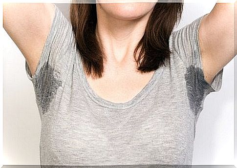 Woman with arms raised - armpit sweating