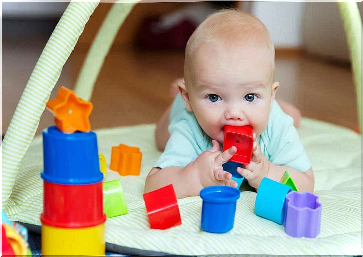 A child with a block in his mouth